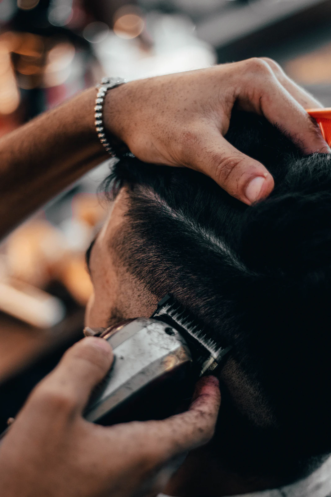 Barber working carefully on a haircut in a studio